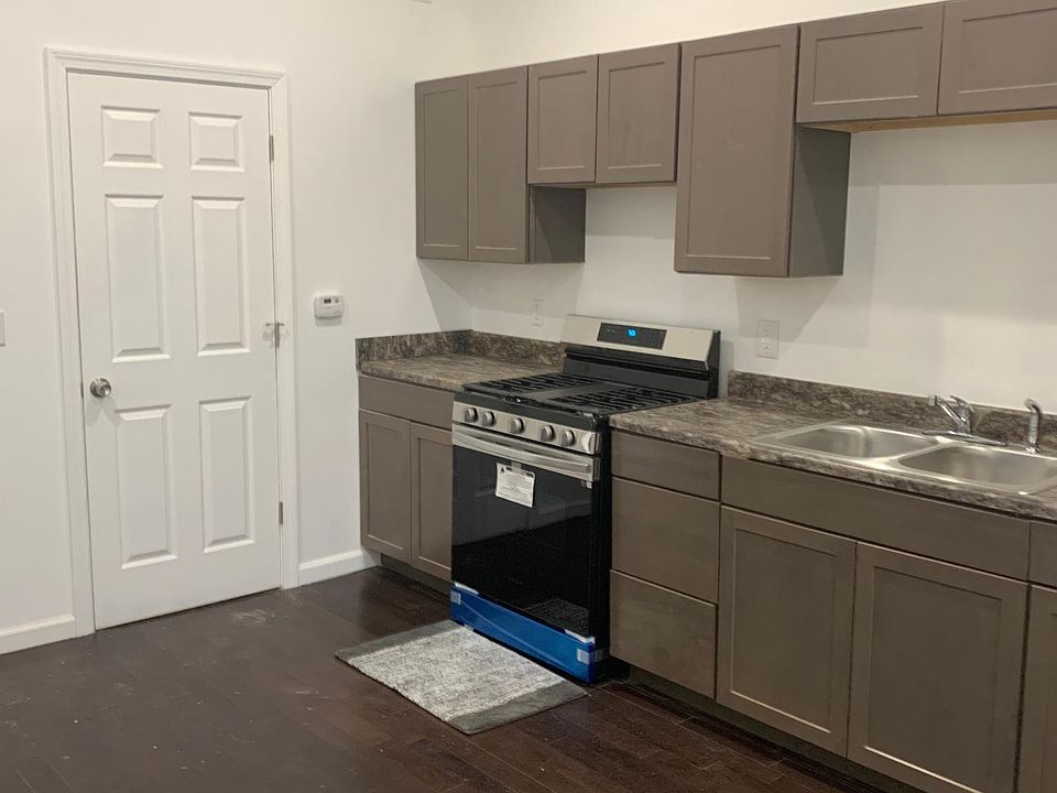 Kitchen with stainless steel refrigerator and stove and hardwood floors