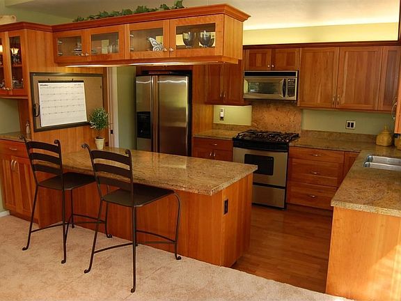 Updated kitchen with stainless refridgerator and granite counters.