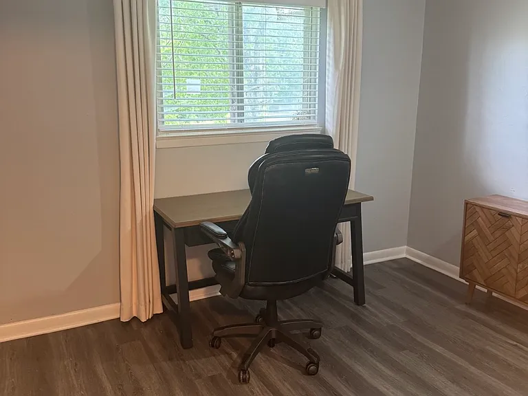 second room set up a office with desk and office chair