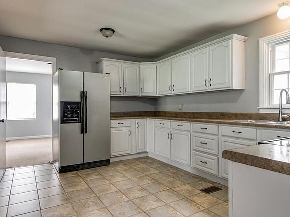 Kitchen very spacious with lots of cabinet space.