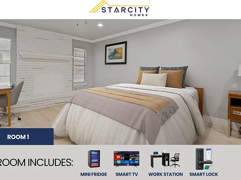 Furnished bedroom with a full bed, nightstands, and a dedicated desk area, plus two windows and a decorative fireplace.