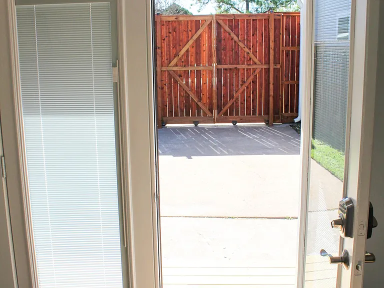 9-foot cedar fence and double-door gate surrounds most of the private shared courtyard.