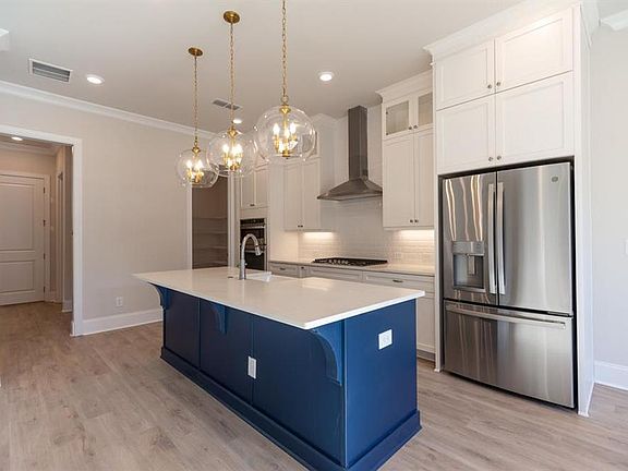 The Hampton II offers a beautifully designed kitchen. This home will have stacked white cabinets and