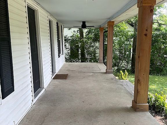 Large, covered front porch with fans.