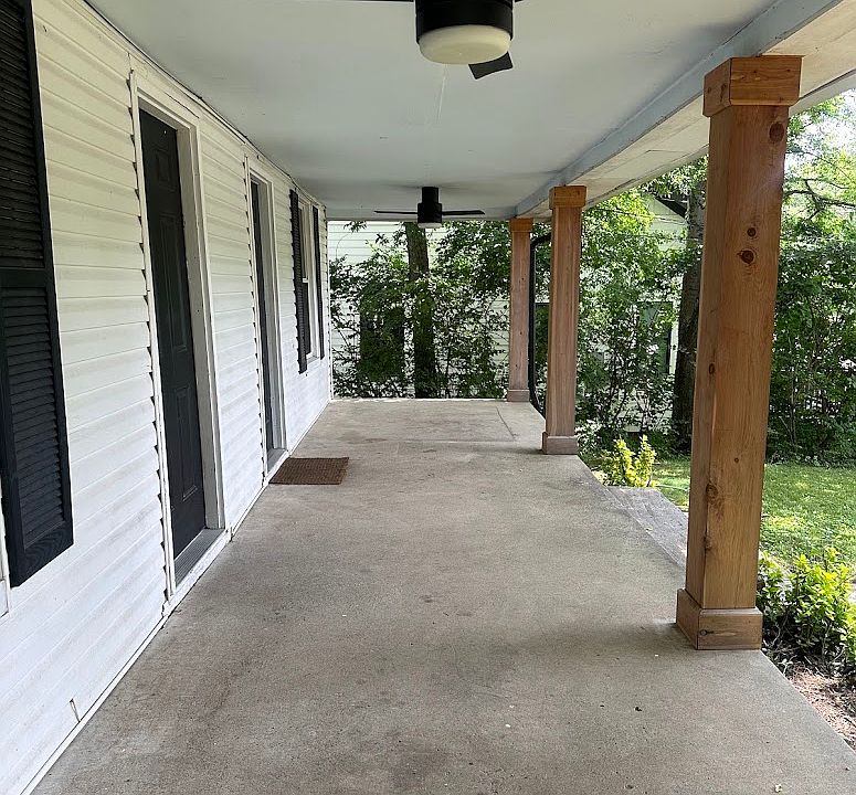 Large, covered front porch with fans.