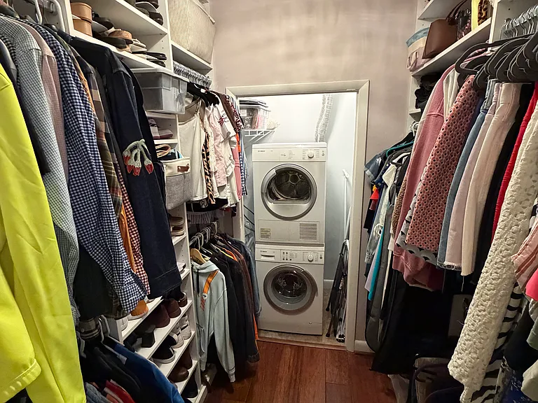 Custom built walk-in closet within the bedroom. Ample storage space for clothes, shoes, bags, etc.