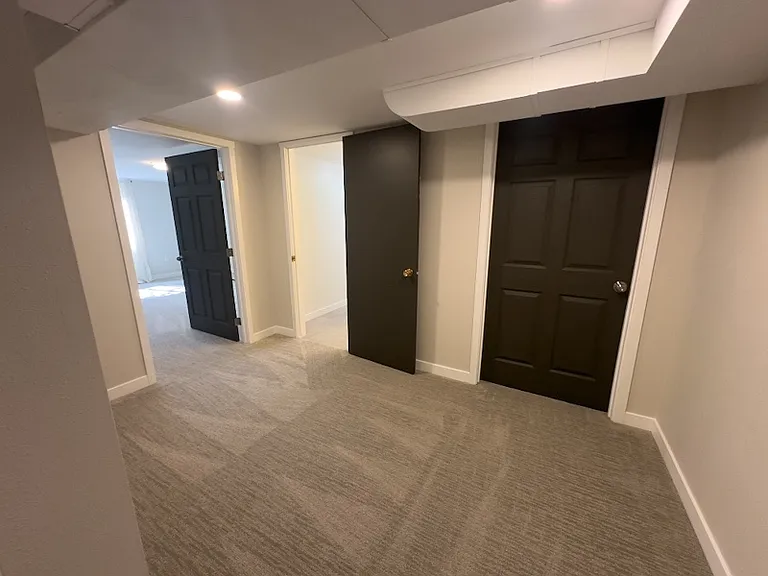 Downstairs hallway to NW corner bedroom, bath, laundry / utility room.