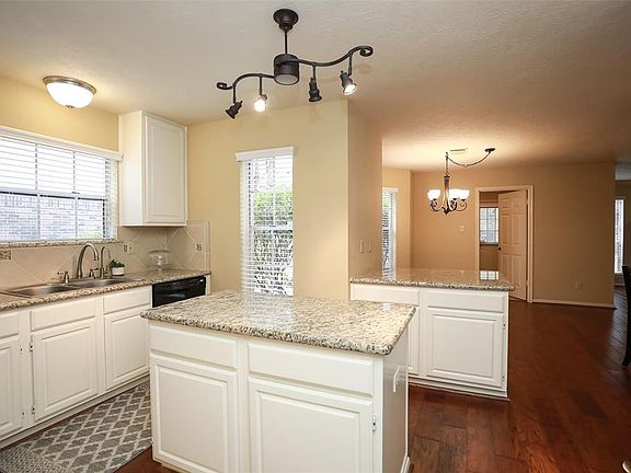 The beautiful lighting in this kitchen along with all the natural light will make you fall in love with the home the minute you walk in.