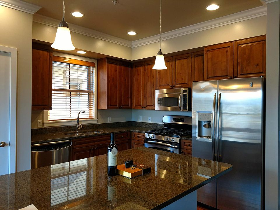 Spacious kitchen with stainless steel appliances, granite countertops and a pantry