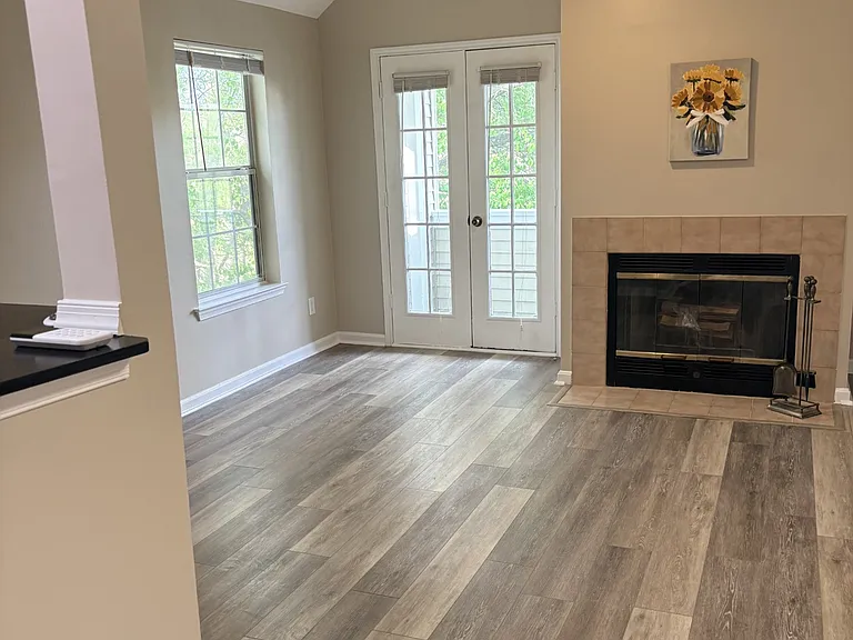 Living Room w/ fireplace, french doors lead to patio/deck