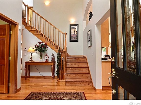 Entry way with welcoming wood floors and staircase.