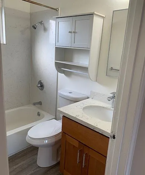 Bath with storage cupboard