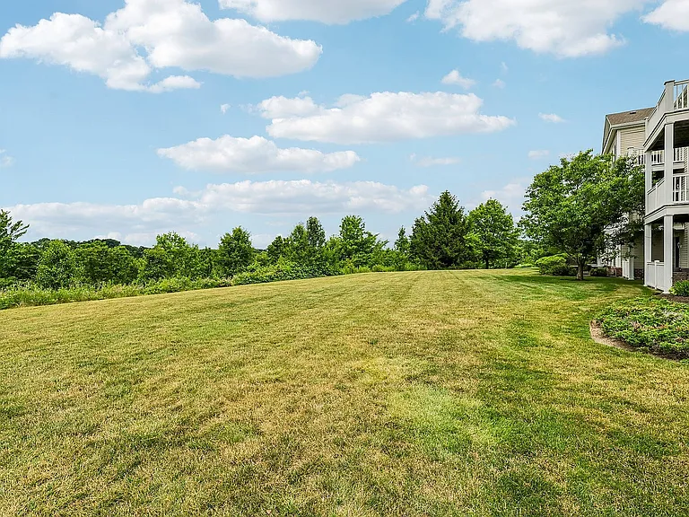 Picturesque apartment view with expansive lush green lawn
