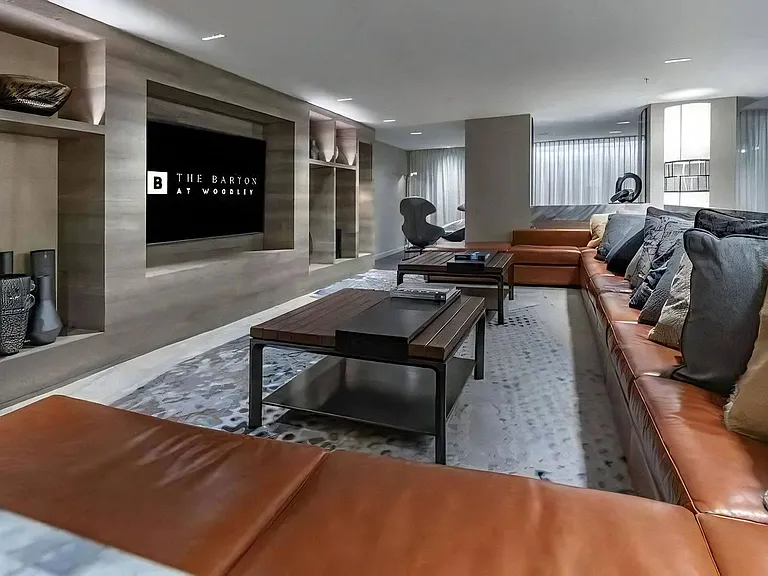 Community Room Featuring Couch Seating, Coffee Tables, and Wall-Mounted TV