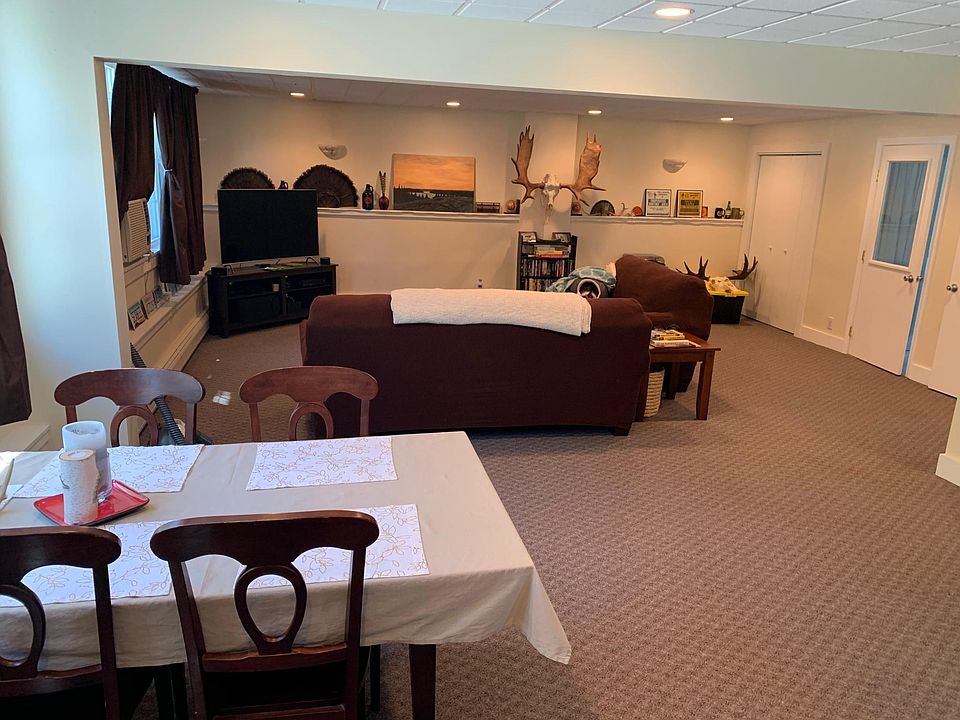 large open plan dinner and living room. Door on the right to utility room and back door.