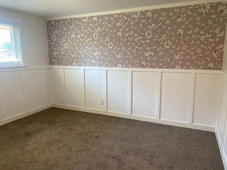 2nd bedroom with classic wallpaper pattern, and board/batten walls.