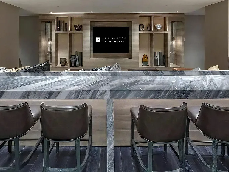 Bar-Style Lounge Area in Clubhouse Facing Built-In Shelving and TV