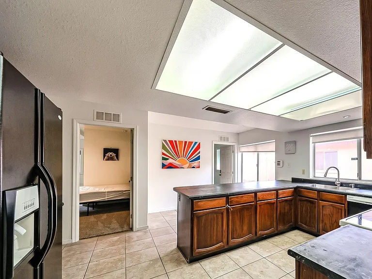 Spacious kitchen with ample counter space, generous cabinetry, and a large window over the sink for everyday convenience.