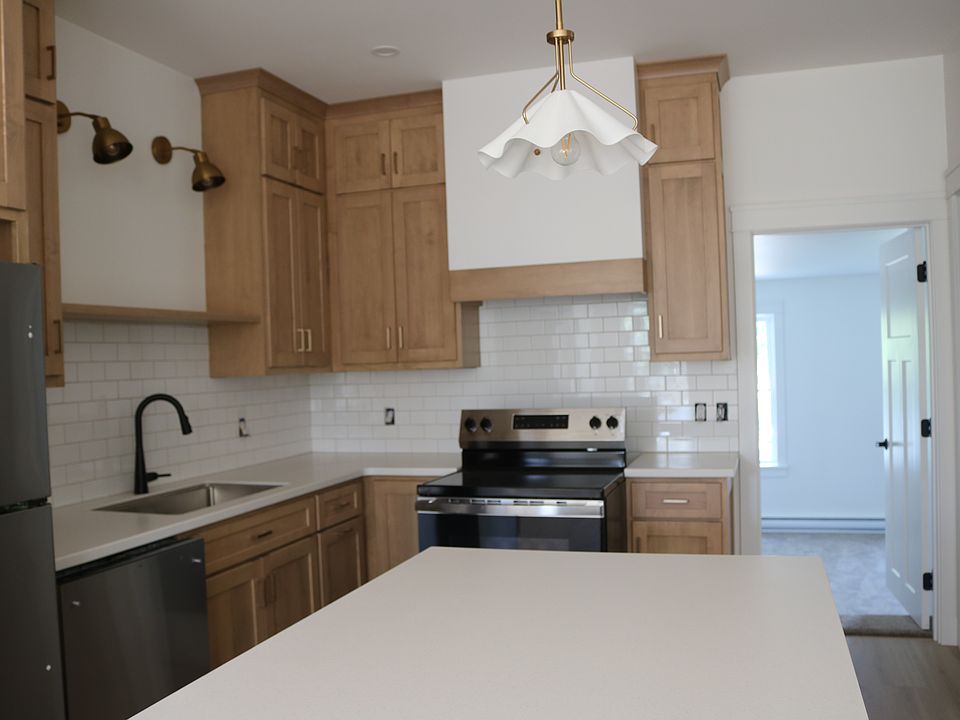 beautiful new custom kitchen with subway tile backsplash and stainless appliances (including dishwasher).