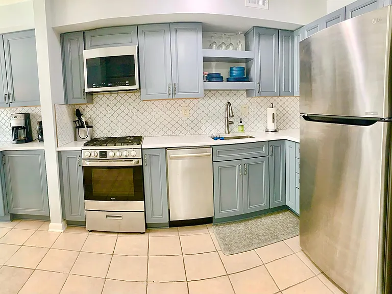 Kitchen includes full-size fridge and compact, yet spacious oven, microwave and dishwasher.