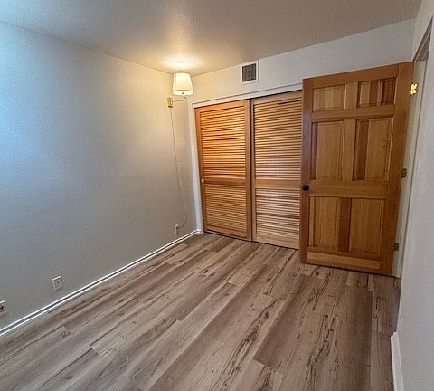 2nd bedroom, left of the front door. The room has a window and a large closet
