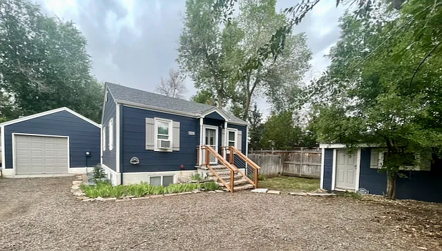 House, attached garage, and storage shed