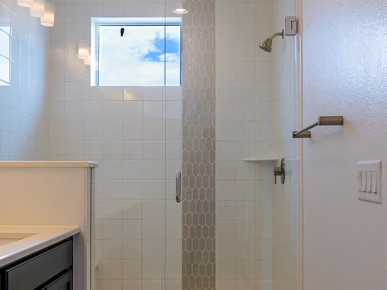 Spacious master bathroom with elegant finishes, dual sink and glass enclosed shower