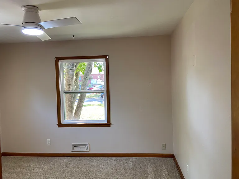 Bedroom 3 at front with fan and large window facing front yard