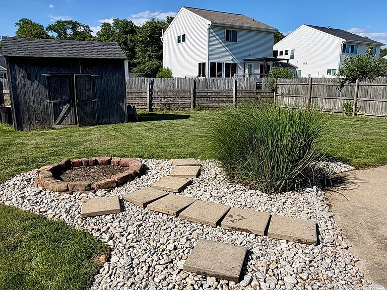 Fully fenced rear yard with large concrete patio and fire-pit, for peaceful and pleasant evening at home