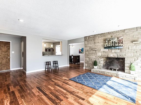 Natural light fills the vast great room with limestone woodburning fireplace