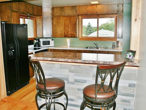 View of the breakfast bar overlooking the kitchen and backyard.