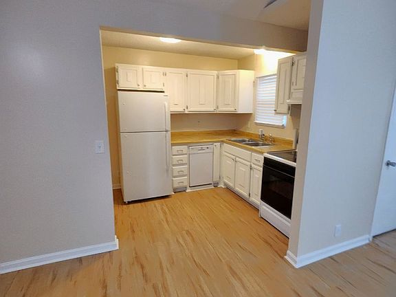 Kitchen with full size refrigerator, oven, and mini dishwasher

(Laundry connections are to the left of the fridge)
