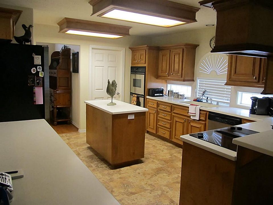   BEAUTIFUL KITCHEN WITH CORIAN COUNTERS. CUSTOM CABINETS, STAINLESS APPLIANCES AND UTILITY ROOM DOOR BY DOUBLE OVEN