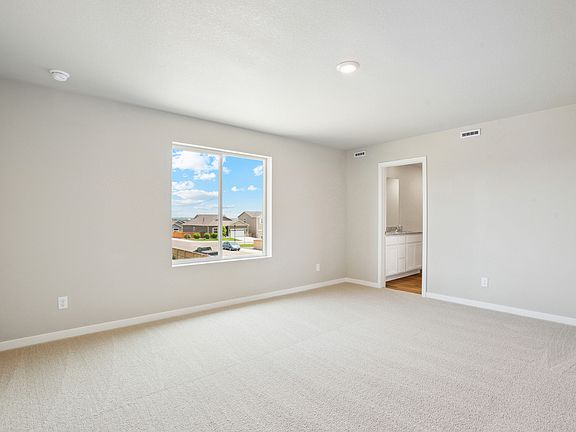 The master bedroom is spacious with a large window.