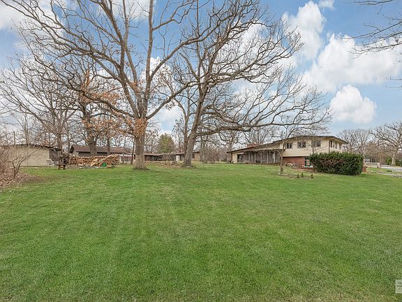 Large .82 acre lot with established landscaping, Conservation At Home pollinator gardens, and multip