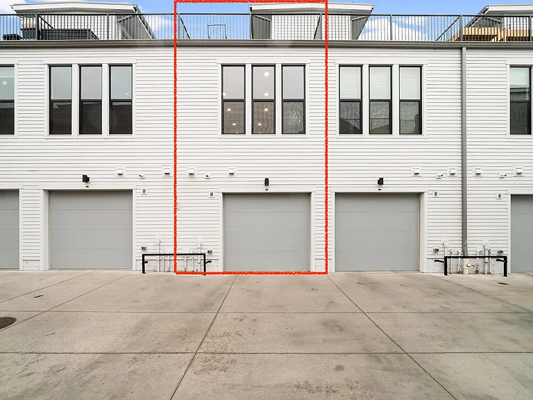 Attached oversized 1.5 car garage with smartphone garage door connectivity, EV charger, and storage space