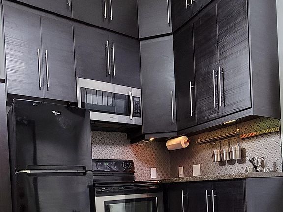 Kitchen with additional storage above (you'll need a step stool or ladder or you could stand on the counter I suppose)