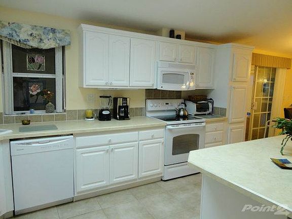 White kitchen with tile floor