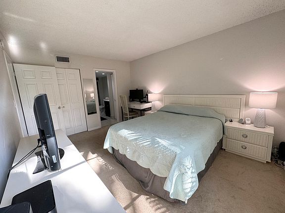 Master bedroom view from window corner seeing desk, closet and bathroom