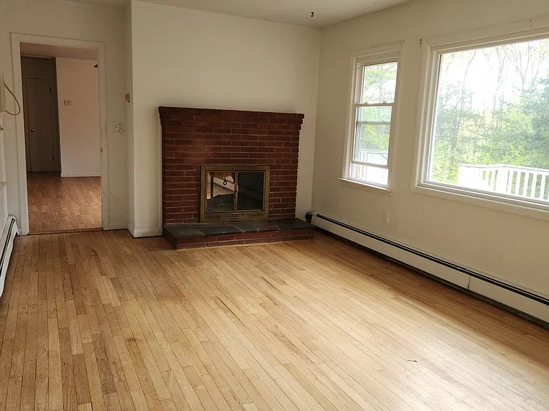 Living Room wioth Double Sided Fire Place Leading in to the Din ging Room