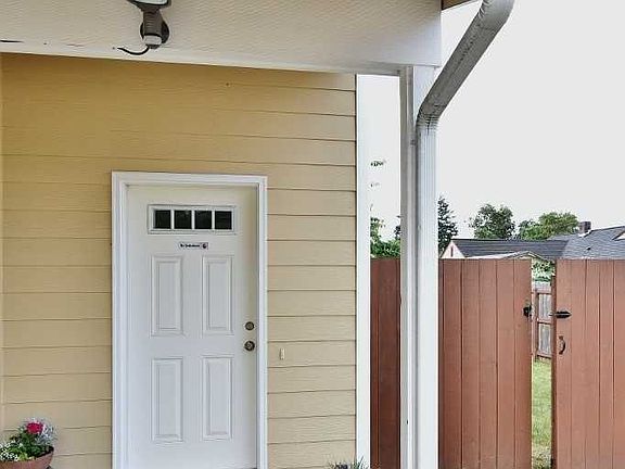 Cover front porch with back yard gate access to right and security camera to see who is there.