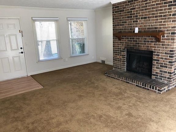 SMALL LIVING ROOM DINING AREA WITH FIREPLACE GAS STARTER, TAKEN FROM KITCHEN DOOR, SLIDING GLASS PATIO DOOR OPENS TO LARGE DECK AND DEEP BACK AREA WITH TREES