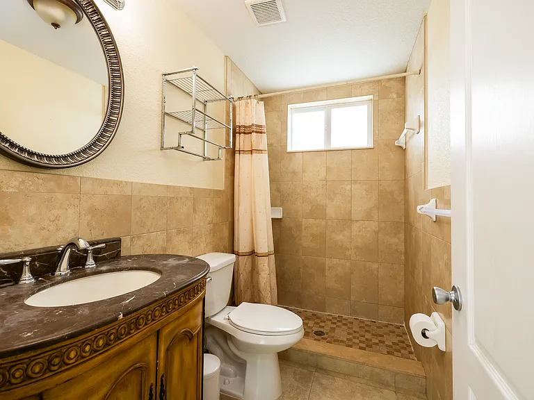 Spacious tiled bathroom freshly painted in light blue/grey