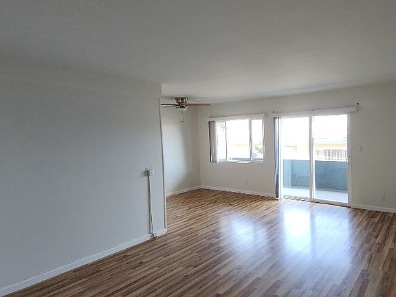 View of dining area, balcony & part of living room from entry