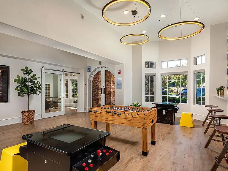 Resident Game Room With Foosball, Arcade, And Lounge Seating