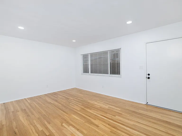 The expansive, sunlit living room features large, energy-efficient dual pane windows.