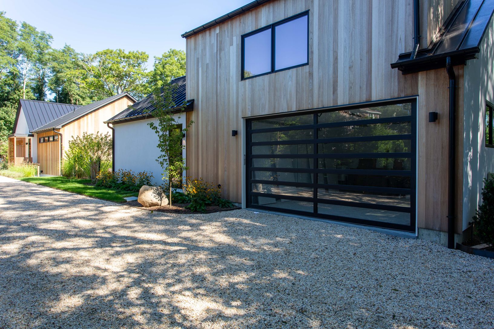  Cottage features mahogany and stucco with huge glass sectional garage door 