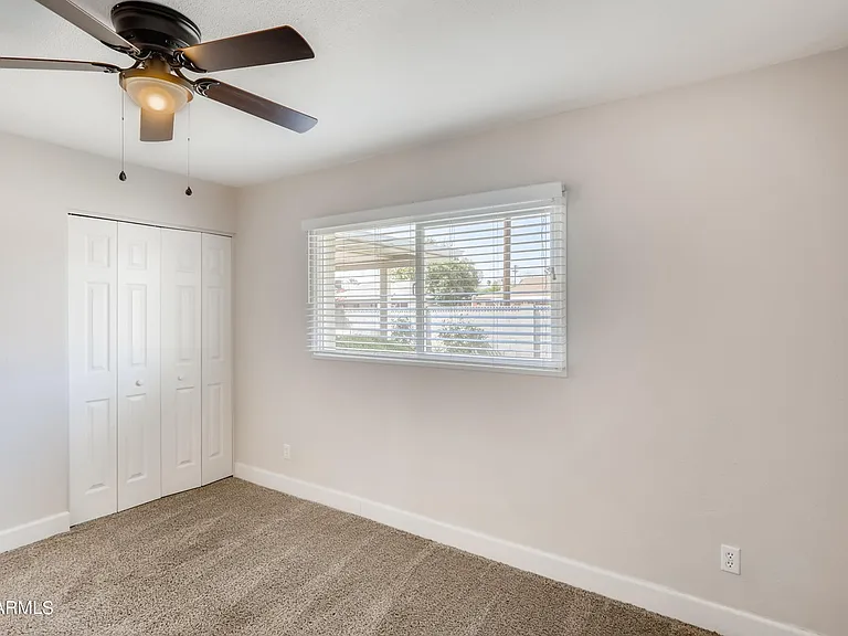 Bedroom 3 is a spacious carpeted room featuring an extra- large closet & great views of lush backyard & pool.