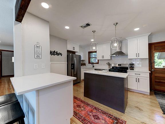 Original wood features and open kitchen with bar stools