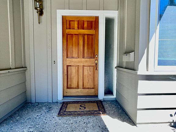 front door with lighting and mailbox
